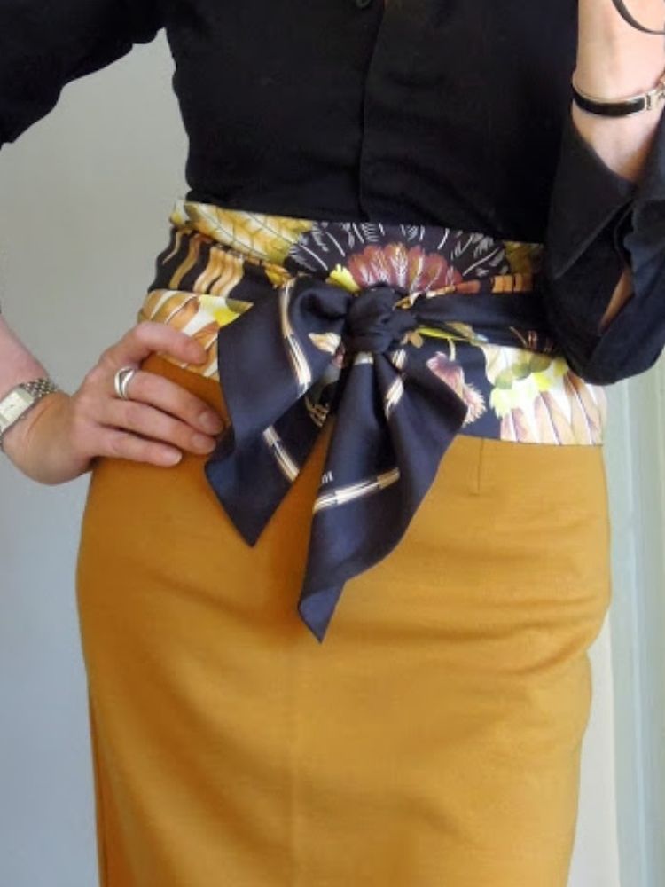 A woman wearing a scarf as a belt