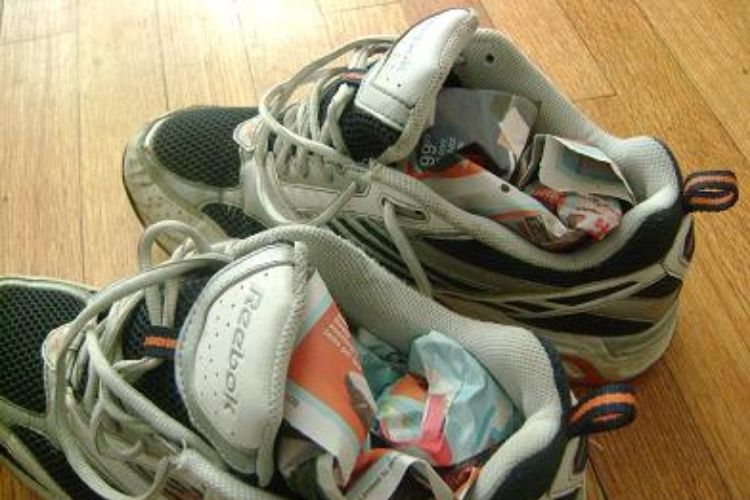 tennis shoes stuffed with newspaper to help them dry