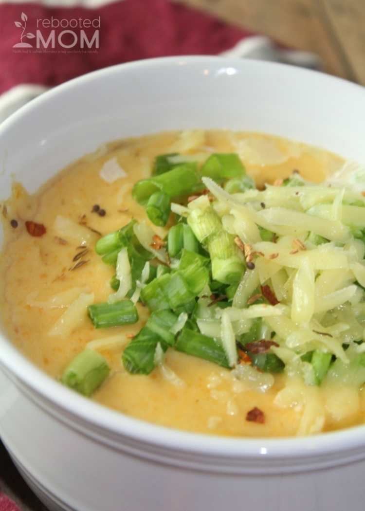 Instant Pot soup recipe for Loaded Chunky Potato Soup - Yummy creamy chunky potato soup garnished with chopped green shallots, shredded potato and sprinkle of red chilli flakes.