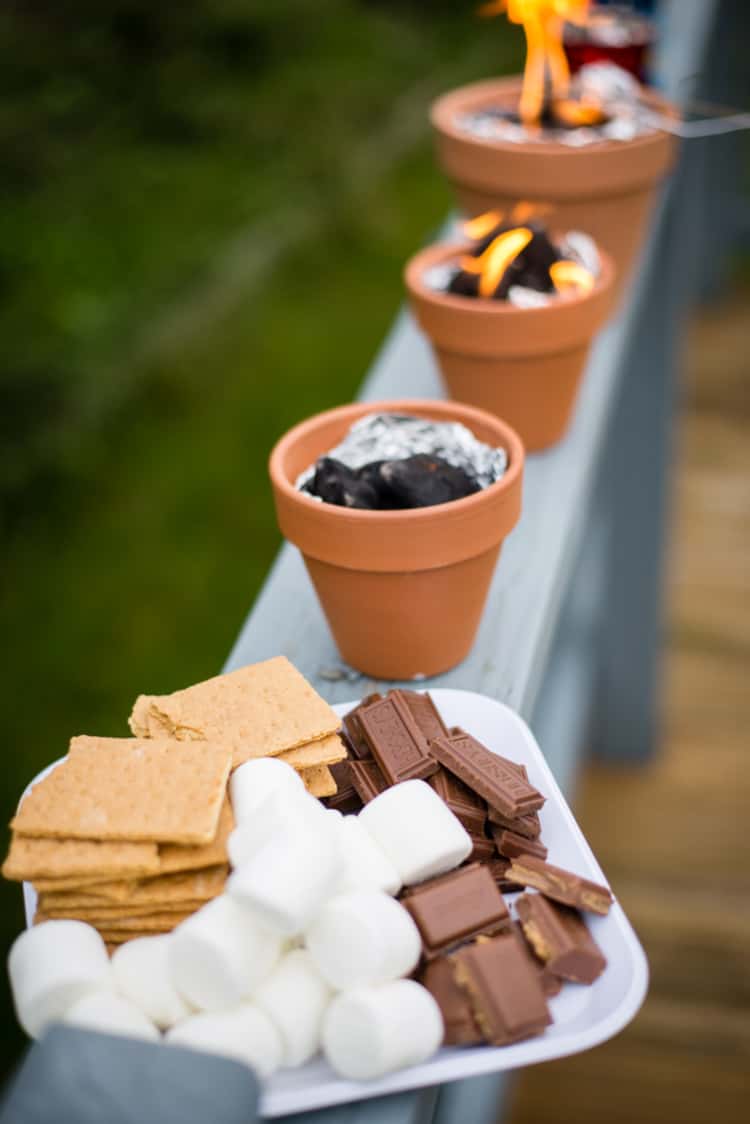 Miniature DIY s'mores pots made from terracotta pots filled with tin foil and charcoal 