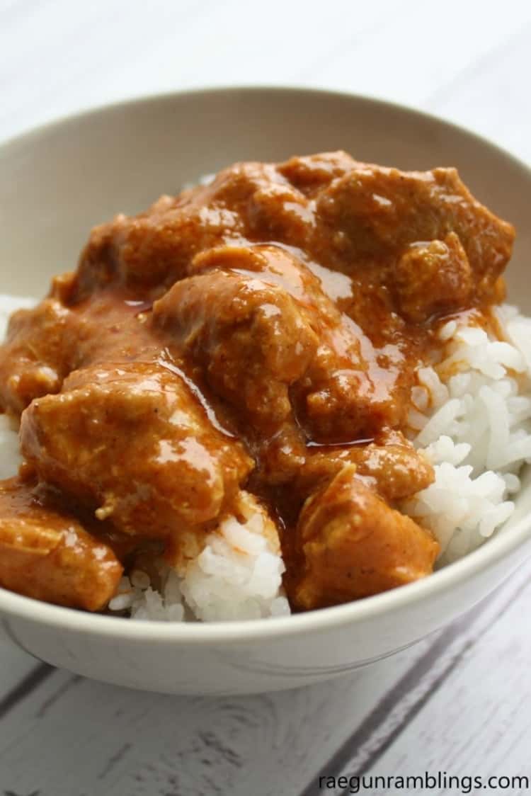 Indian Butter Pressure Cooker Chicken over sticky rice in a bowl , Instant Pot Chicken Recipe 