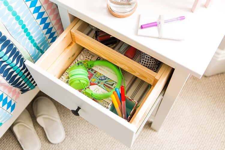 cleaning projects - an organized nightstand with open drawers showing compartmentalized drawers 