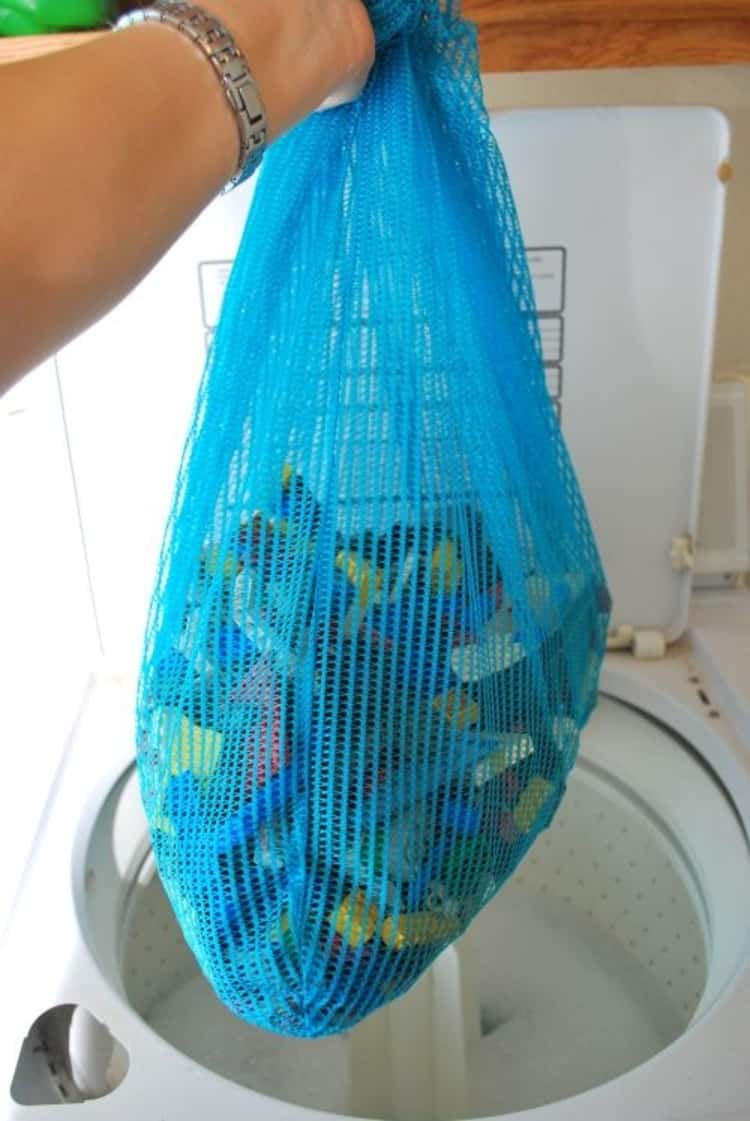cleaning projects - toys in a meshed bag being removed from the washing machine