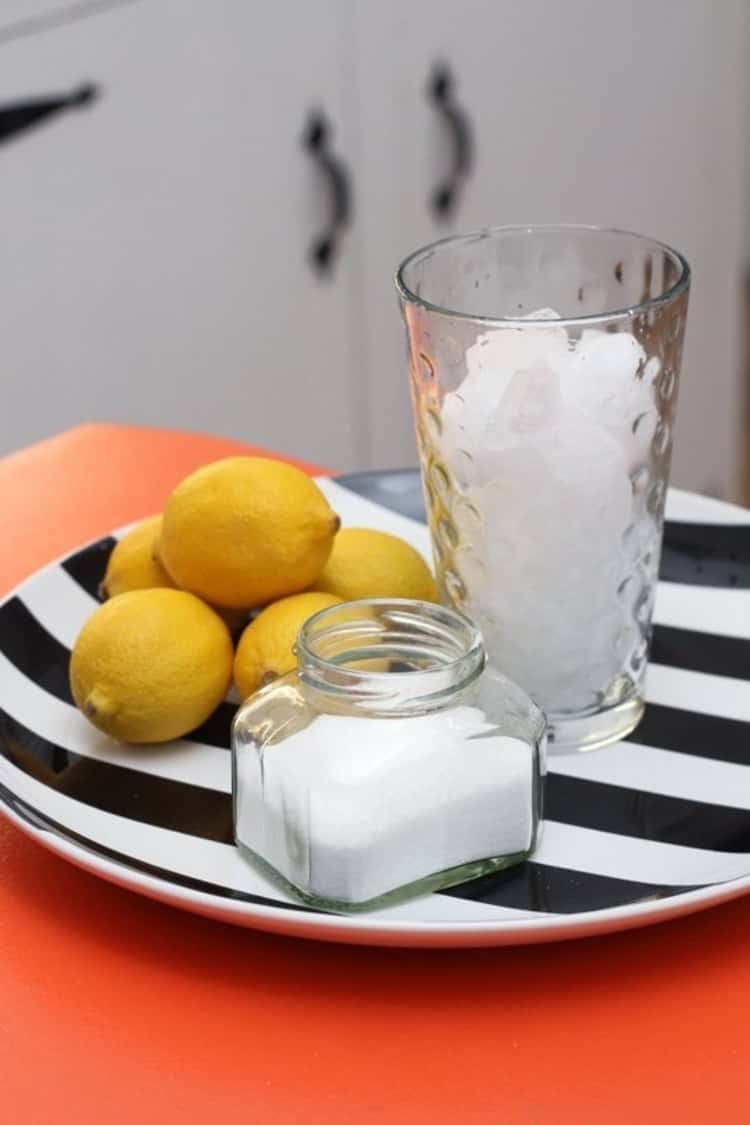 Lemons, a glass of ice cubes and baking soda used to clean and deodorize a garbage disposal unit. Some cleaning projects are unbelievably simple! 