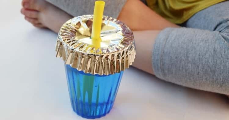 Picnic hack - a cupcake liner placed over a glass and has a straw punched through to keep bugs out of a drink
