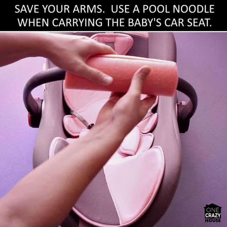 photo showing baby hack to save your arms by using a pool noodle when carrying the baby's car seat