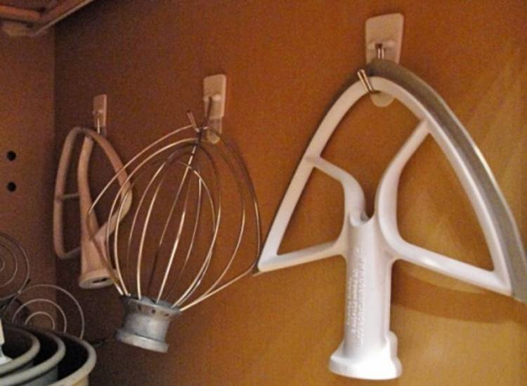 unusual command hook use to hand kitchen aid attachments inside kitchen cupboards