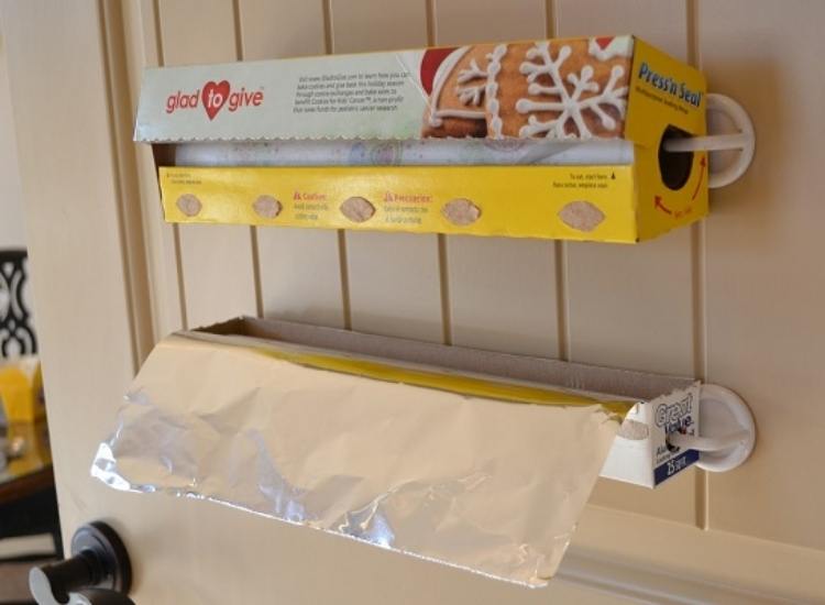 unusual command hook use to hang foil and plastic wrap in kitchen cabinet 