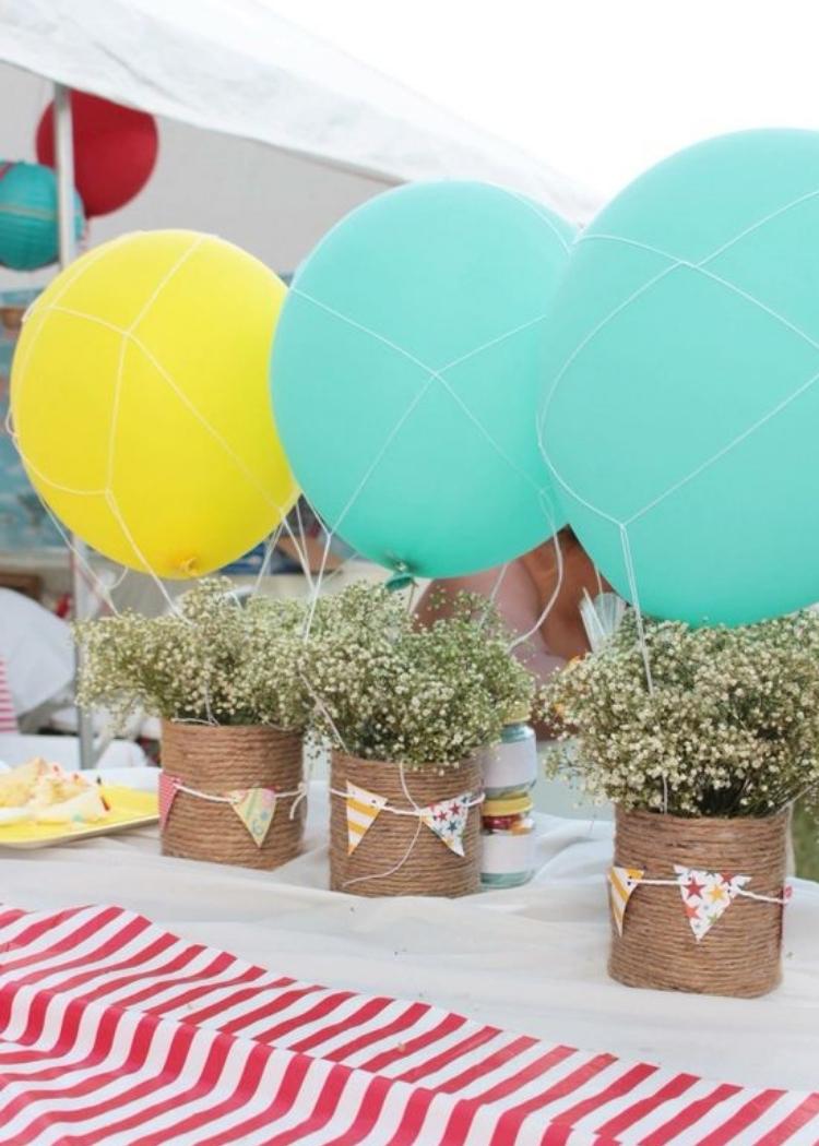 Mimic mini hot air balloons made out of old cans, giving them new life as centerpieces.