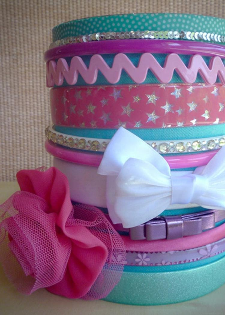 Colorful headbands and bows decorate this canister in fun fashion. 