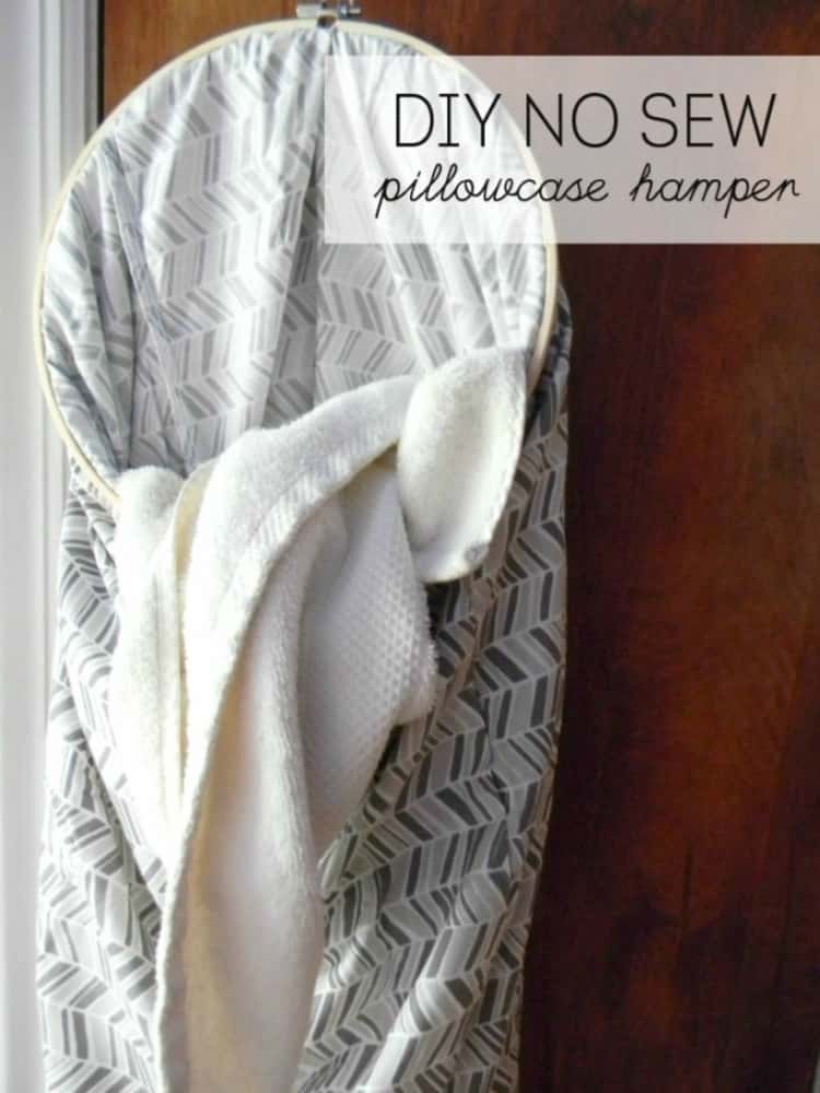 A DIY NO SEW pillowcase hamper hung on a door and holds a dirty towel