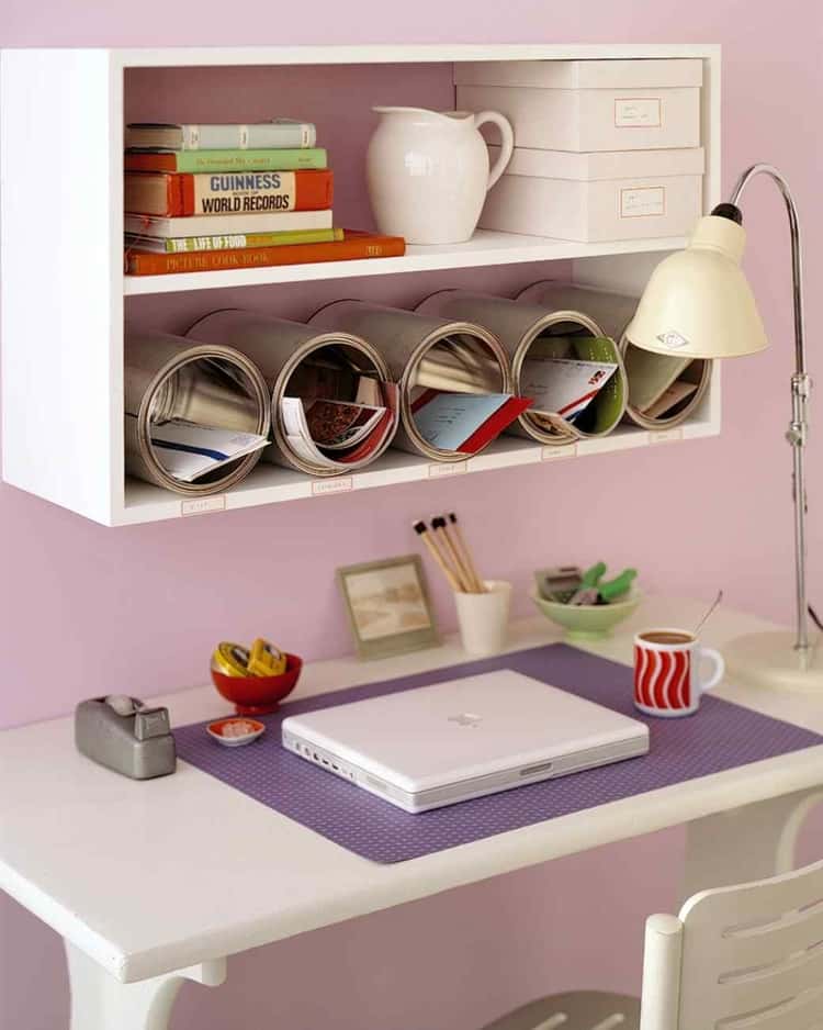 Paint cans being reused to sort mail on a shelf in the office 