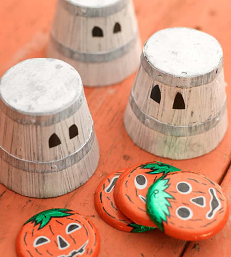 3 upside down spooky pails and plates set up in readiness for the guess which cup/pail Halloween game