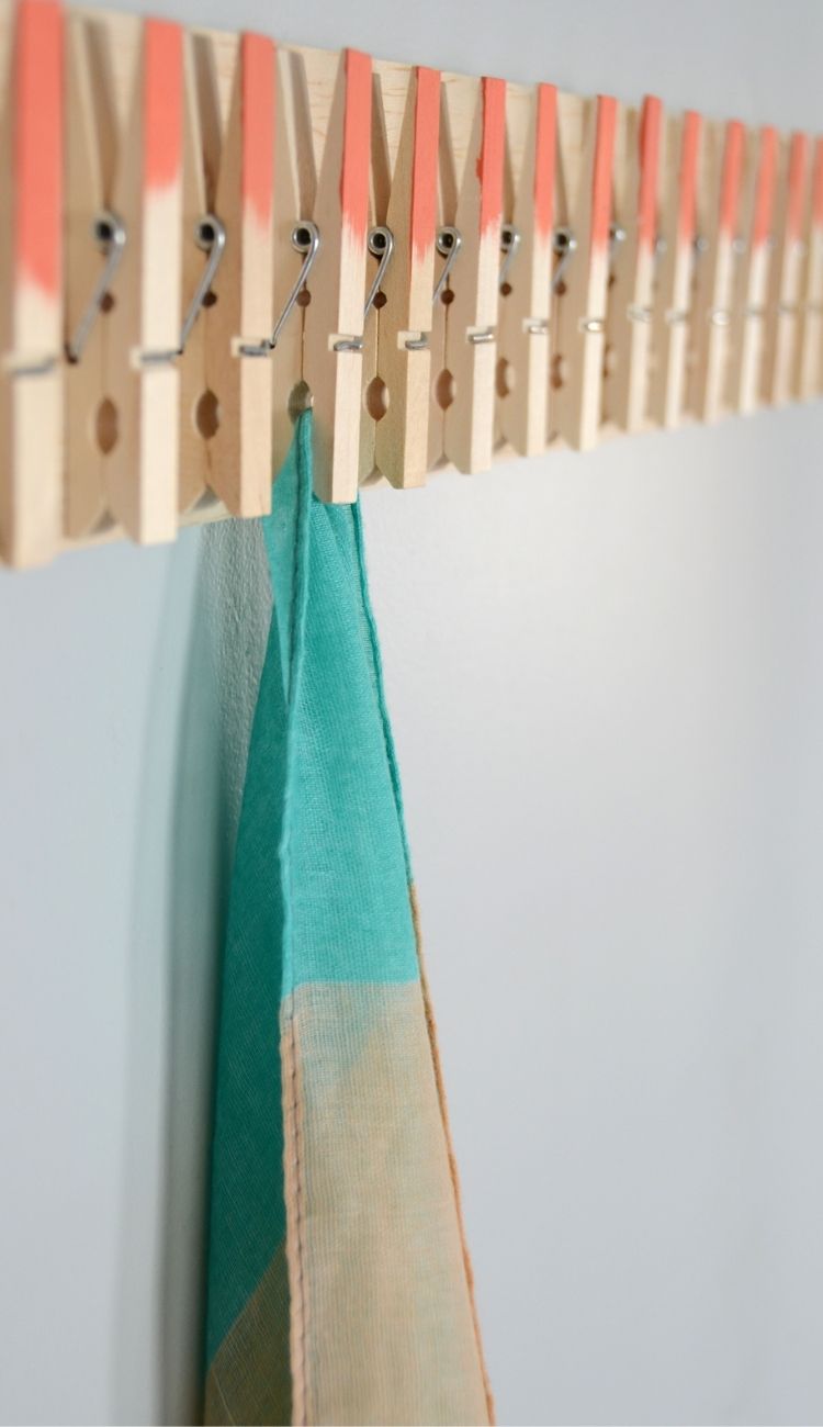 one scarf hanging from a DIY clothespin rack