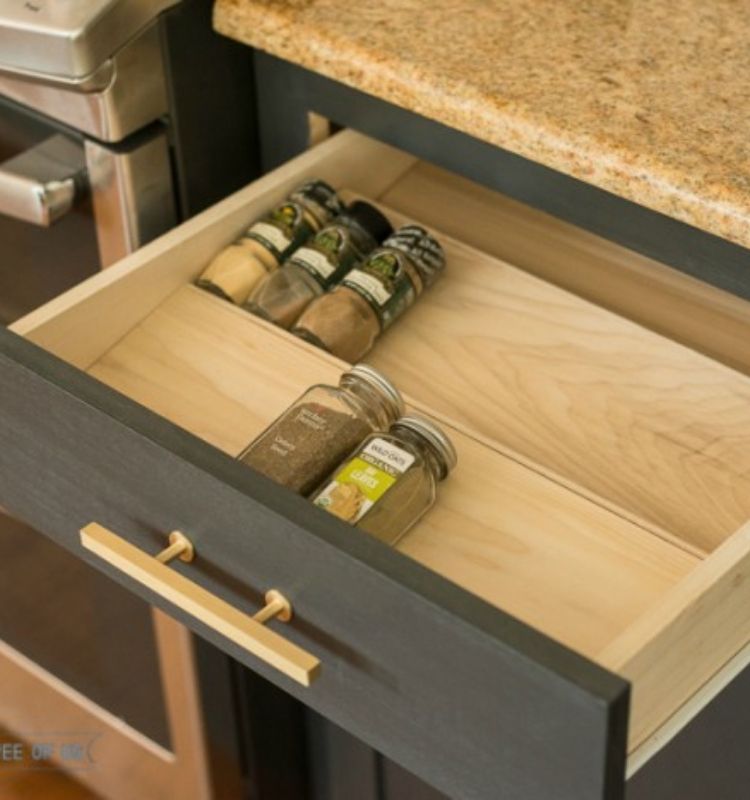 a few spices in their original jars lined in a custom made spice drawer