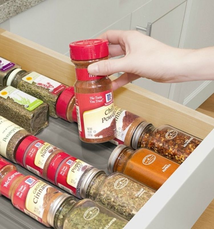 spices in their original jars lined in spiceliners in a drawer