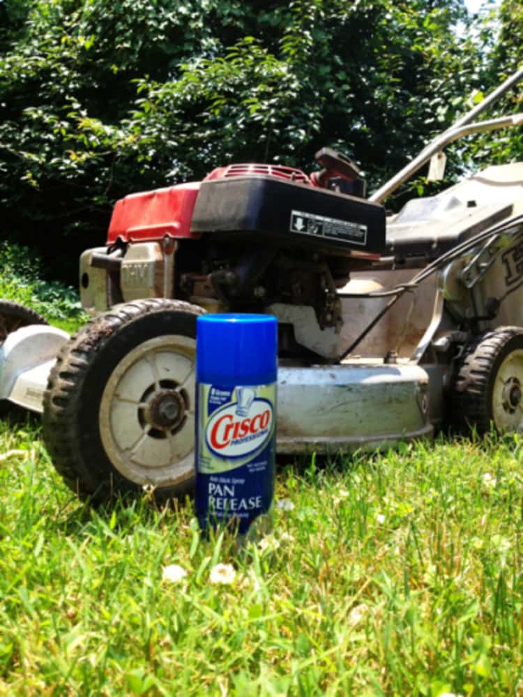 A lawn mower and a cooking spray can.