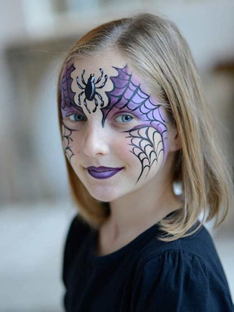 girl with black and purple spider web and spider on her face
