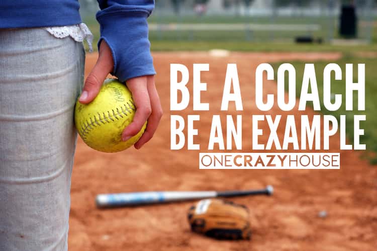 Be a coach, be an example. A photo of someone holding a baseball with a bat and a glove lying on the ground behind them