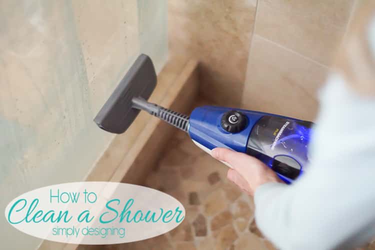 Woman using a steam cleaner machine to clean a shower door