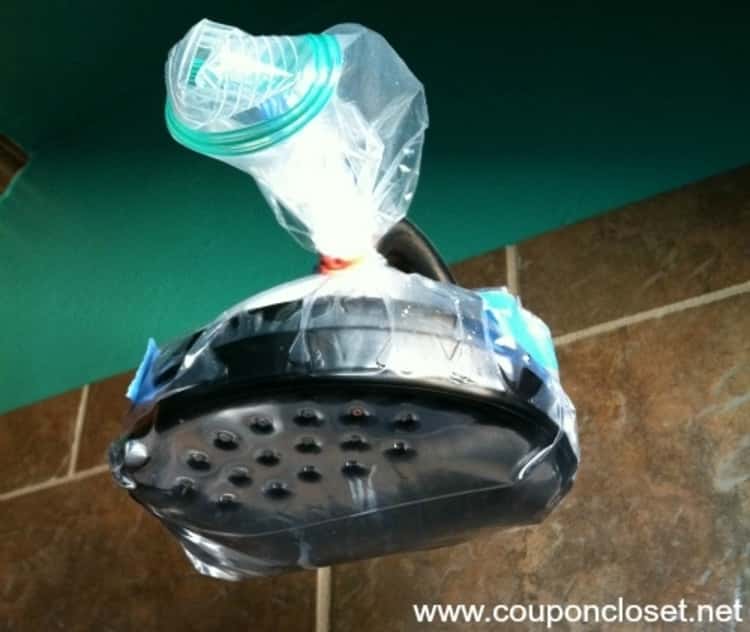 Shower head with plastic baggie containing vinegar tied around and over it 