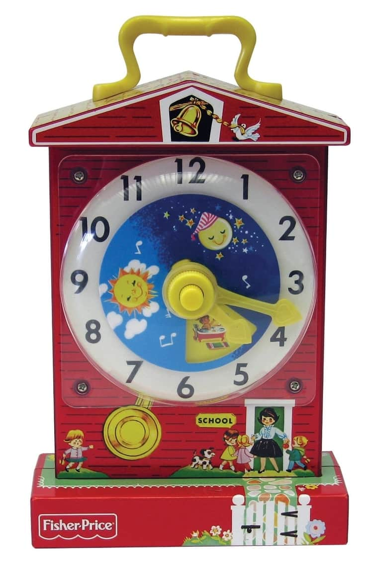 Photo of vintage toy red clock with yellow hands, a moon and a sun, by Fisher Price. 