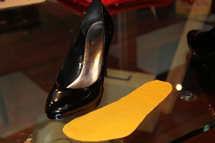 black high heel shoes with a orange diy sole next to it