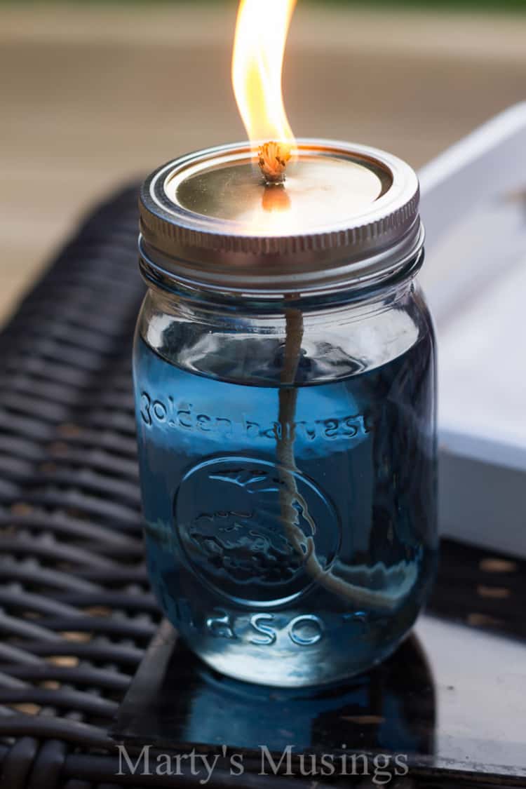 a lit paraffin candle jar