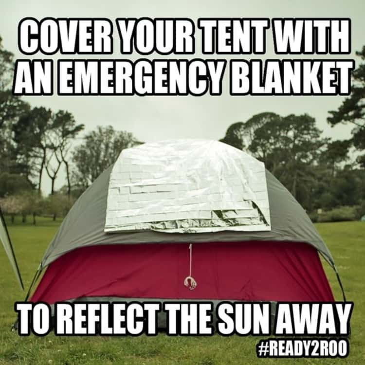 An emergency blanket placed over a tent to reflect light away