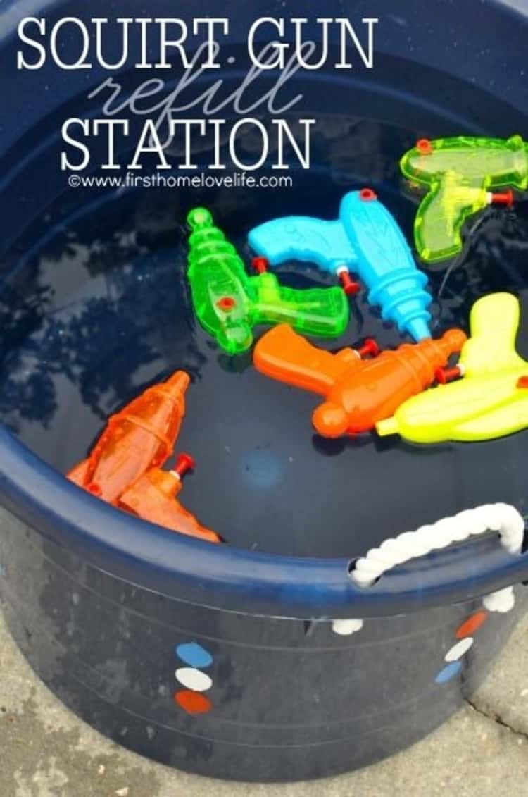 Squirt guns placed in a bucket of water to make a squirt gun station for the kids and adults too!